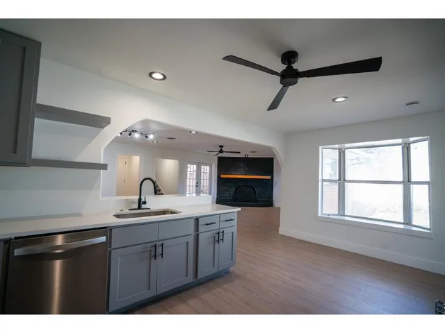 a kitchen with a sink cabinets and window