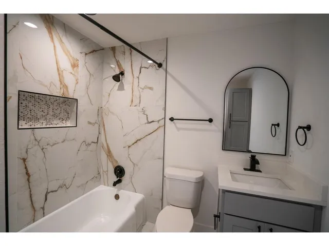 a bathroom with a sink toilet and shower