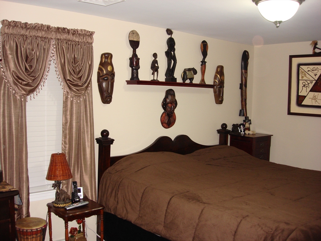 223 Charge Pond Road Wareham, MA 02571 - Photo 2 of 10 a bedroom with a bed and wall paintings