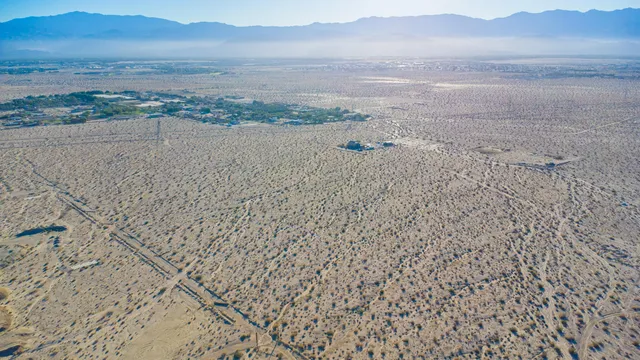 a view of an ocean beach and mountain