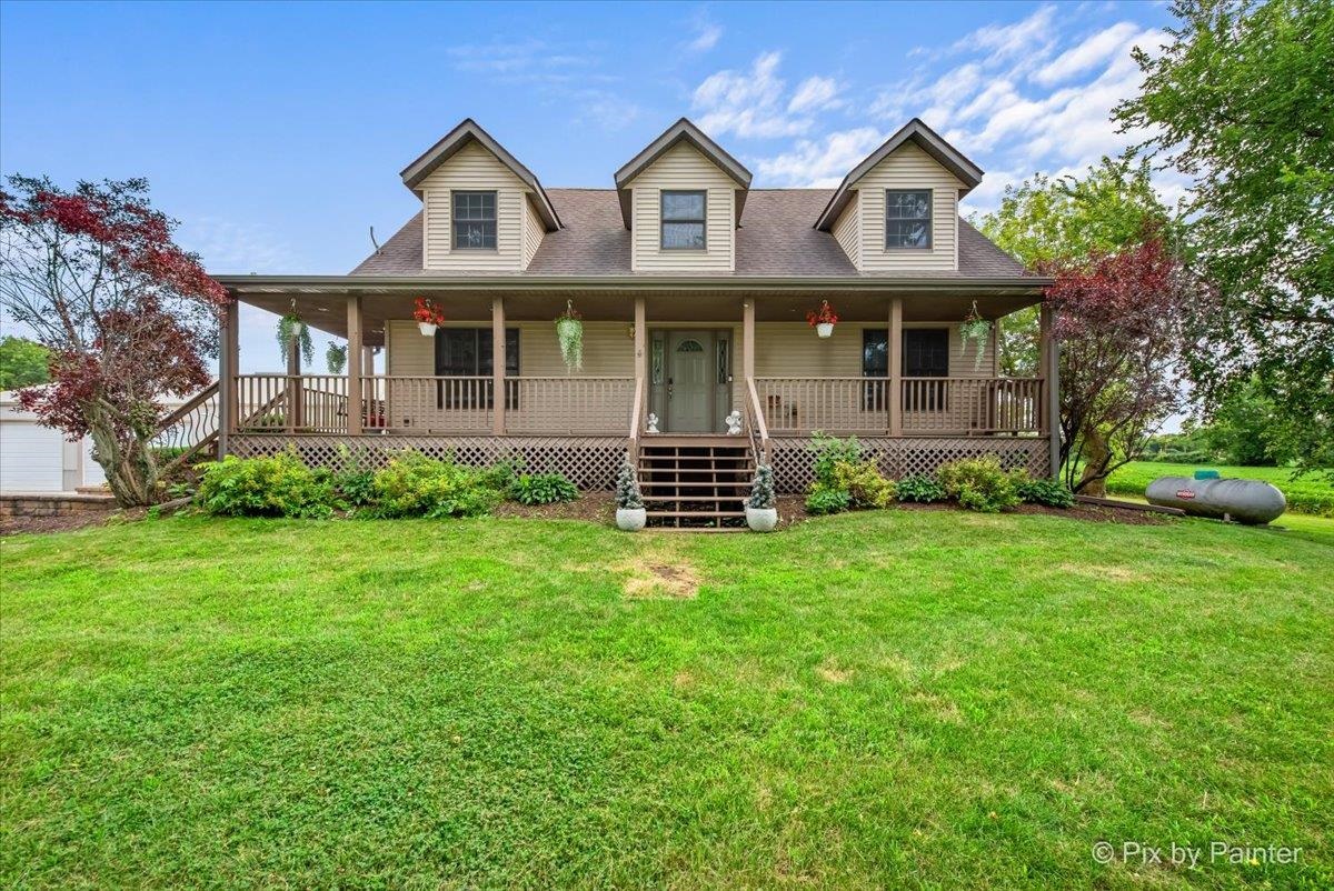 10053 Spring Road Garden Prairie, IL 61038 - Photo 1 of 17 a front view of a house with garden