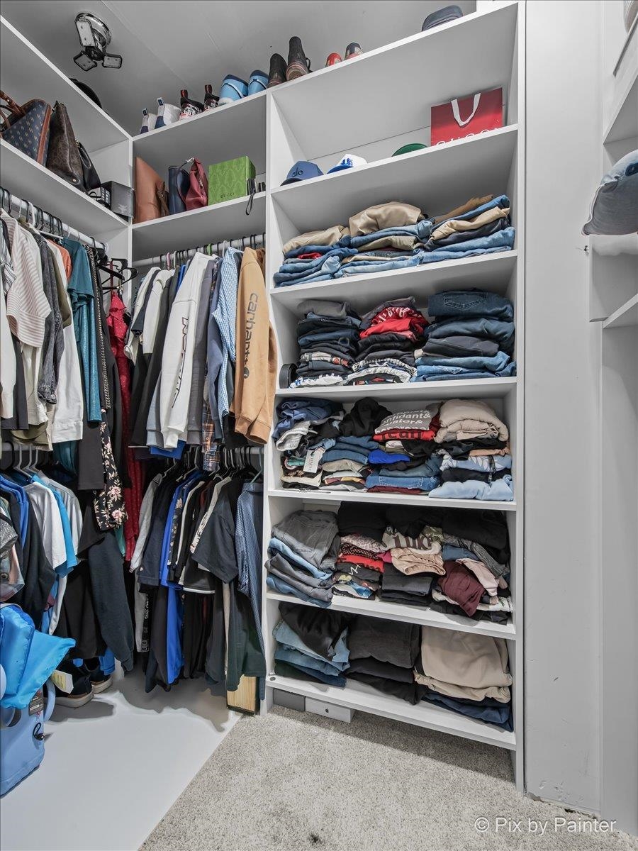 10053 Spring Road Garden Prairie, IL 61038 - Photo 12 of 17 a view of walk in closet with clothes and shoes