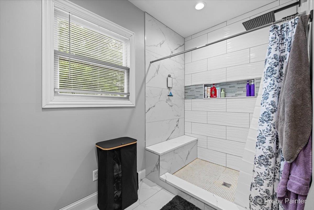 10053 Spring Road Garden Prairie, IL 61038 - Photo 13 of 17 a bathroom with a bathtub and shower