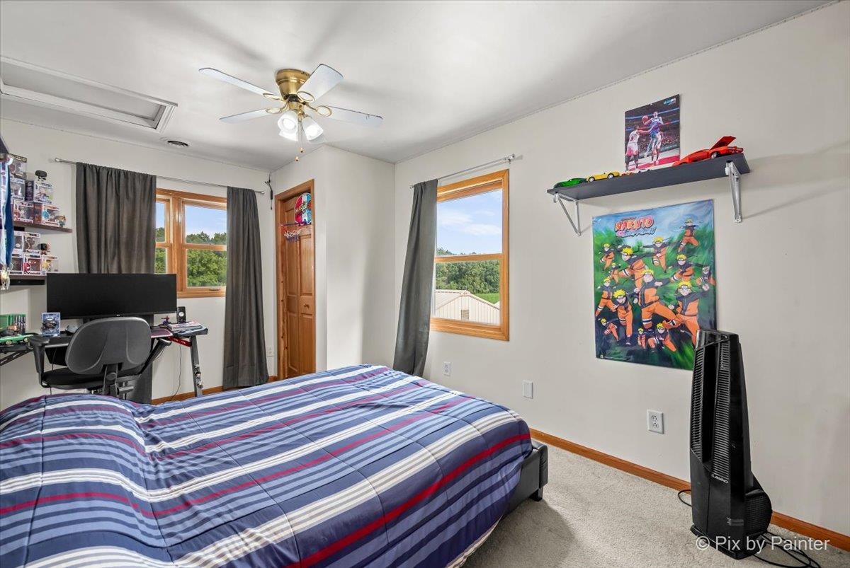 10053 Spring Road Garden Prairie, IL 61038 - Photo 15 of 17 a bedroom with a bed and a chandelier
