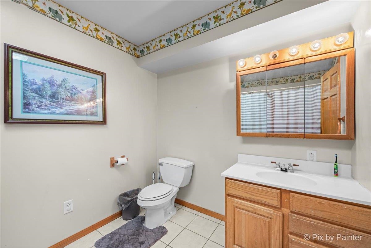 10053 Spring Road Garden Prairie, IL 61038 - Photo 16 of 17 a bathroom with a toilet sink and mirror