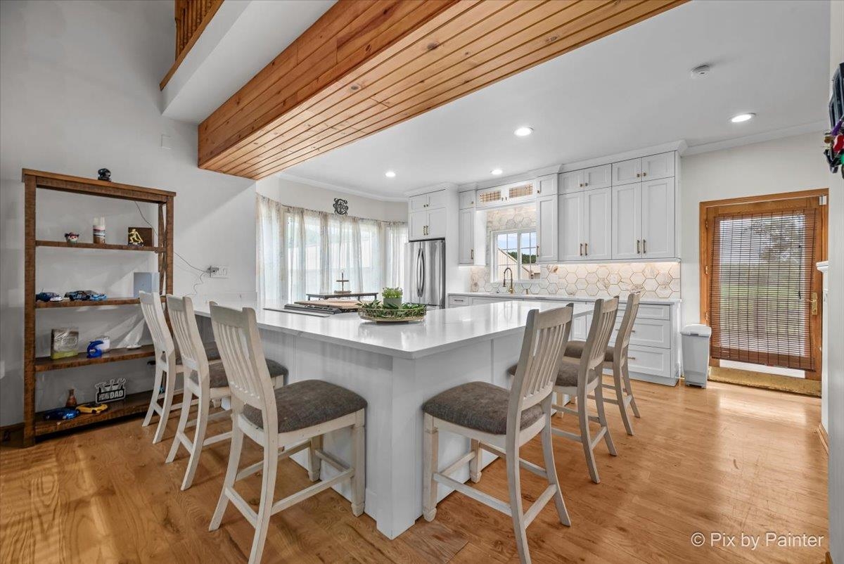 10053 Spring Road Garden Prairie, IL 61038 - Photo 5 of 17 a view of a dining room with furniture and wooden floor