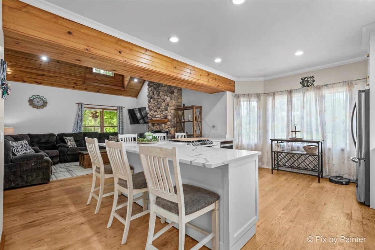 10053 Spring Road Garden Prairie, IL 61038 - Photo 6 of 17 a kitchen with stainless steel appliances kitchen island granite countertop a table and chairs