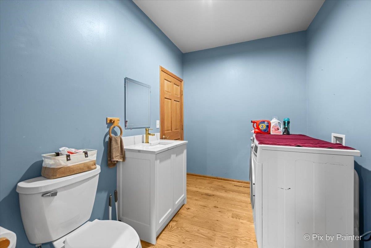 10053 Spring Road Garden Prairie, IL 61038 - Photo 10 of 17 a bathroom with a sink toilet vanity and tub