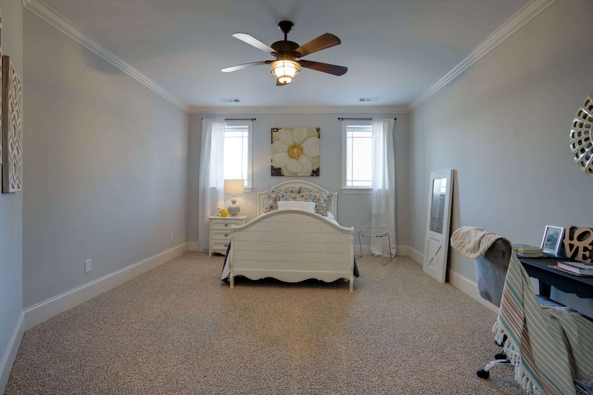 8254 Patterson Road College Grove, TN 37046 - Photo 26 of 30 a spacious bedroom with a bed and a chandelier
