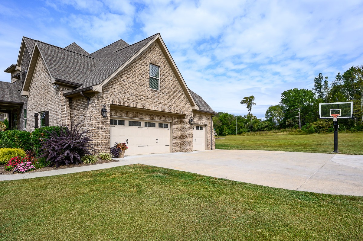 8254 Patterson Road College Grove, TN 37046 - Photo 29 of 30 a front view of a house with a garden and yard