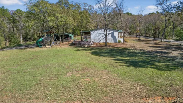 a view of a yard with a tree