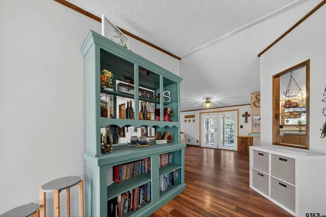 a kitchen with stainless steel appliances a refrigerator a sink wooden floor and cabinets