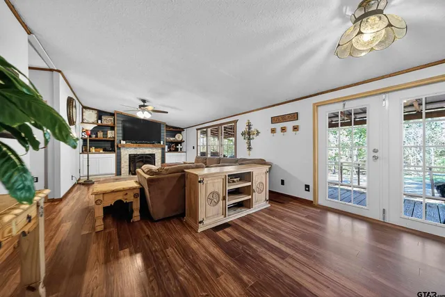 a living room with furniture a flat screen tv and a fireplace