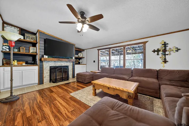 a living room with furniture and a wooden floor