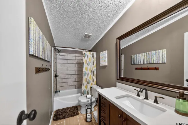 a bedroom with bed and wooden floor