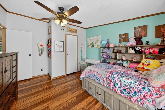 a view of a bedroom with furniture and flat screen tv