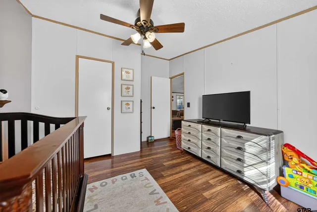 a living room with stainless steel appliances kitchen island granite countertop furniture and a flat screen tv