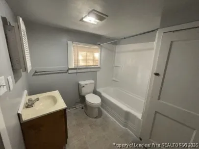 a bathroom with a toilet a sink and bathtub