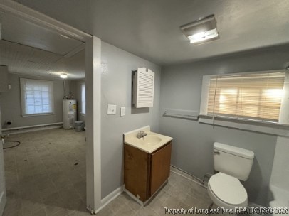 1614 Reeves Street Fayetteville, NC 28306 - Photo 13 of 14 a bathroom with a toilet sink vanity and mirror