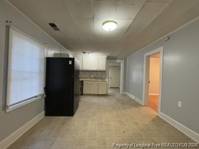 1614 Reeves Street Fayetteville, NC 28306 - Photo 4 of 14 a view of a refrigerator in kitchen and a window
