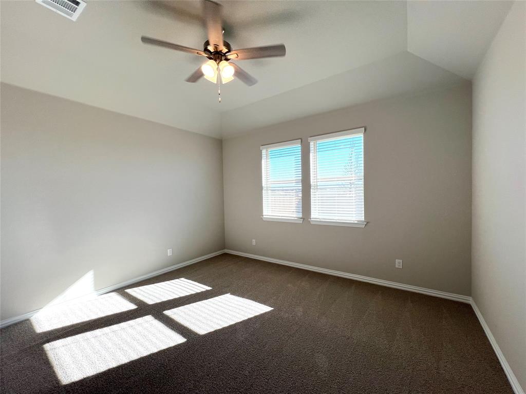 3305 Cross Shr Drive Anna, TX 75409 - Photo 17 of 31 Carpeted empty room featuring ceiling fan, a raised ceiling, and vaulted ceiling