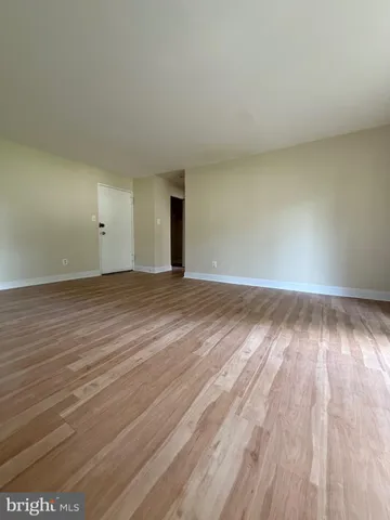 a view of an empty room and wooden floor