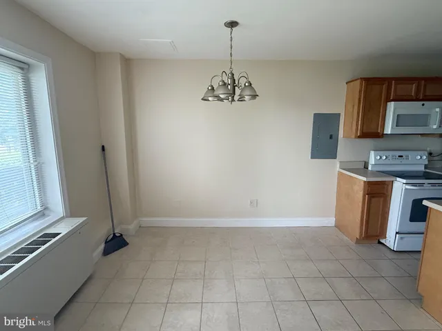 a view of a kitchen with a sink dishwasher and fireplace