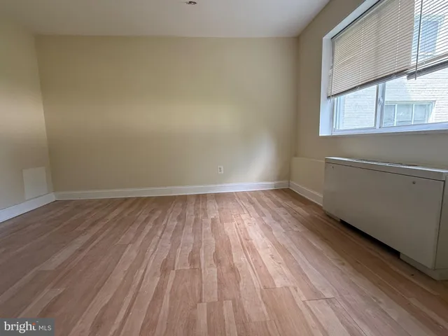a view of a room with wooden floor and brick walls
