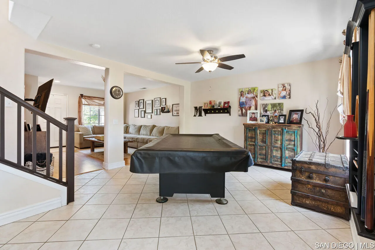 27201 Wildsmith Road Menifee, CA 92584 - Photo 7 of 24 a living room with furniture and a flat screen tv