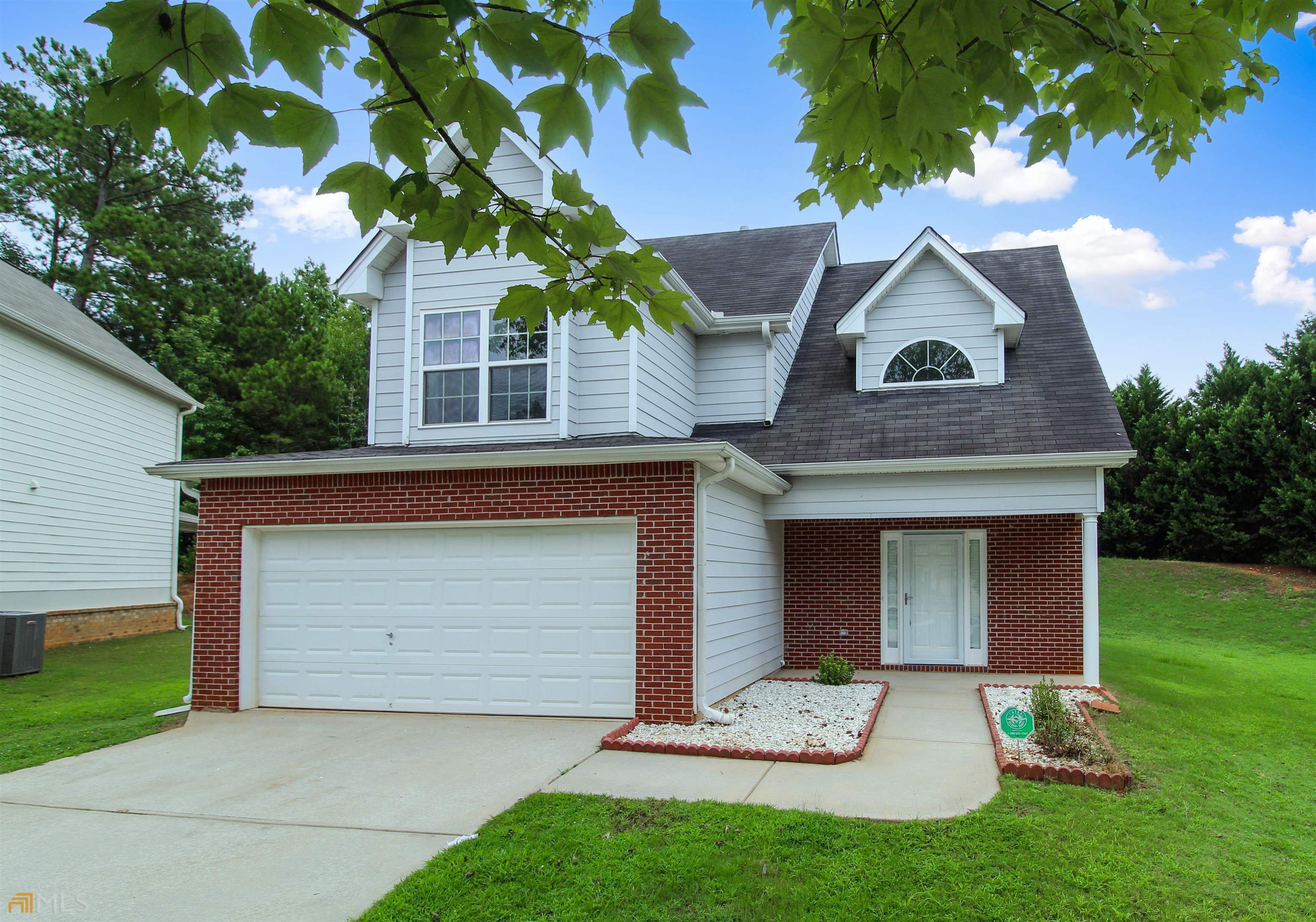 236 Sableshire Way Locust Grove, GA 30248 - Photo 1 of 1 a front view of a house with a yard and garage