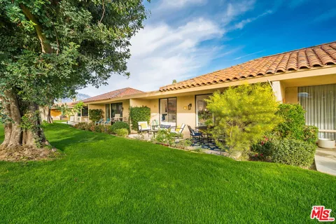 a spacious bedroom with a bed and a flat screen tv