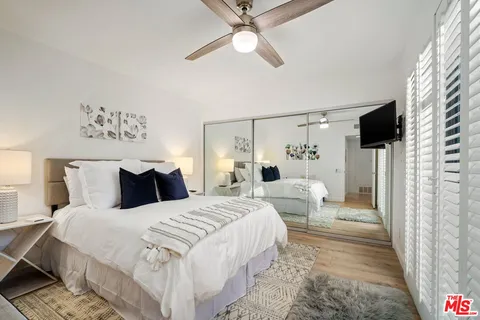 a bedroom with a large bed and a chandelier