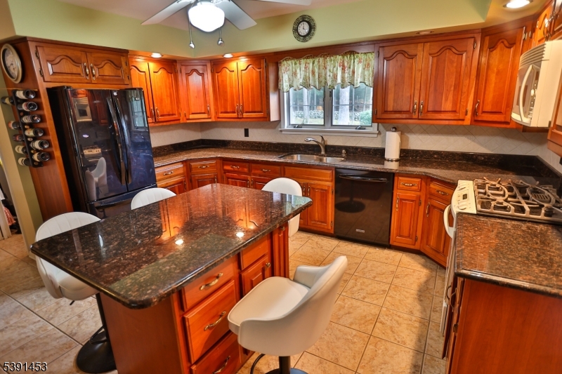 47 New Mashipacong Road Montague, NJ 07827 - Photo 18 of 42 a kitchen with stainless steel appliances granite countertop a stove a sink dishwasher and cabinets with wooden floor
