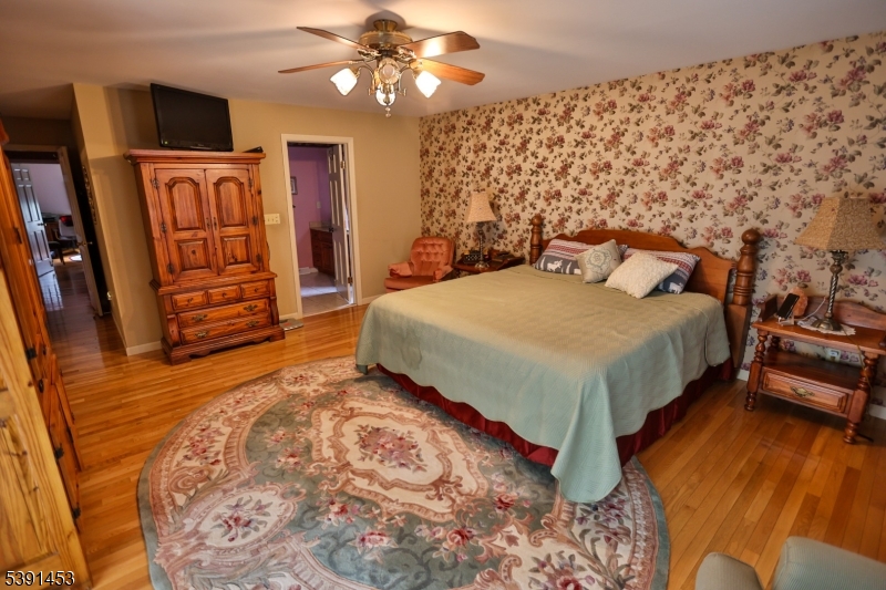 47 New Mashipacong Road Montague, NJ 07827 - Photo 21 of 42 a spacious bedroom with a bed and a flat screen tv