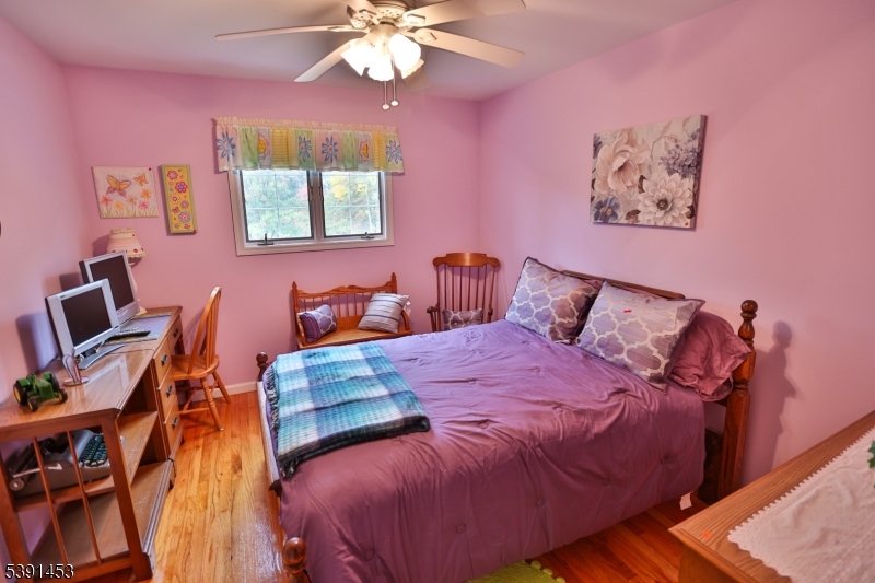 47 New Mashipacong Road Montague, NJ 07827 - Photo 27 of 42 a bedroom with bed and a chandelier