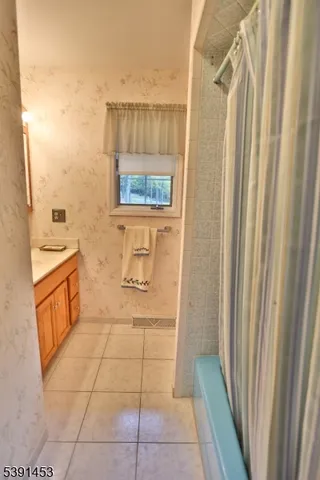 a bathroom with a toilet a sink and a mirror