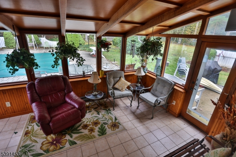 47 New Mashipacong Road Montague, NJ 07827 - Photo 33 of 42 a living room with furniture and a floor to ceiling window