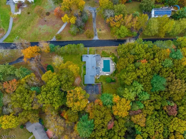 an aerial view of a houses with a yard