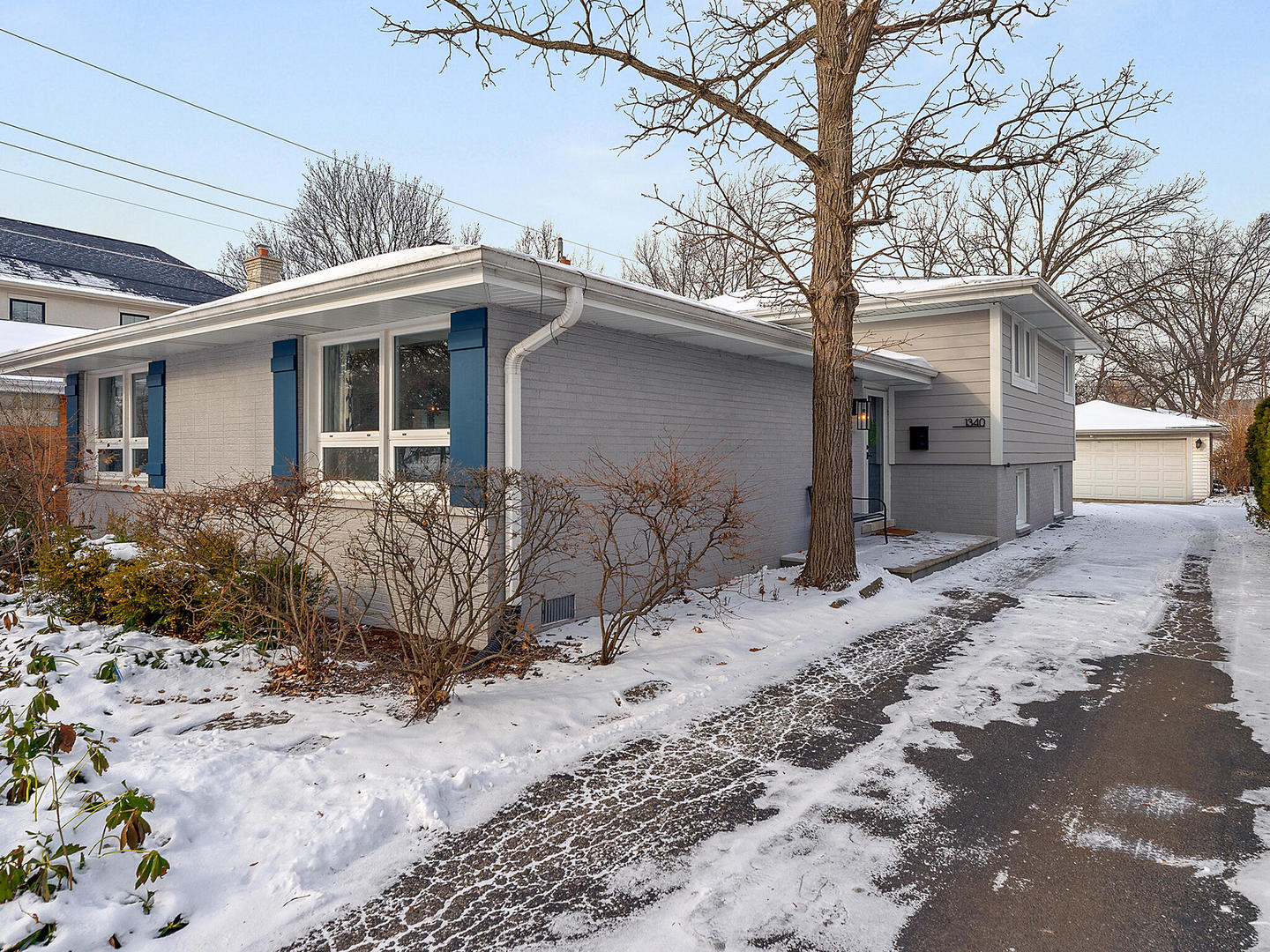 a view of a house with a yard covered with snow in front of house