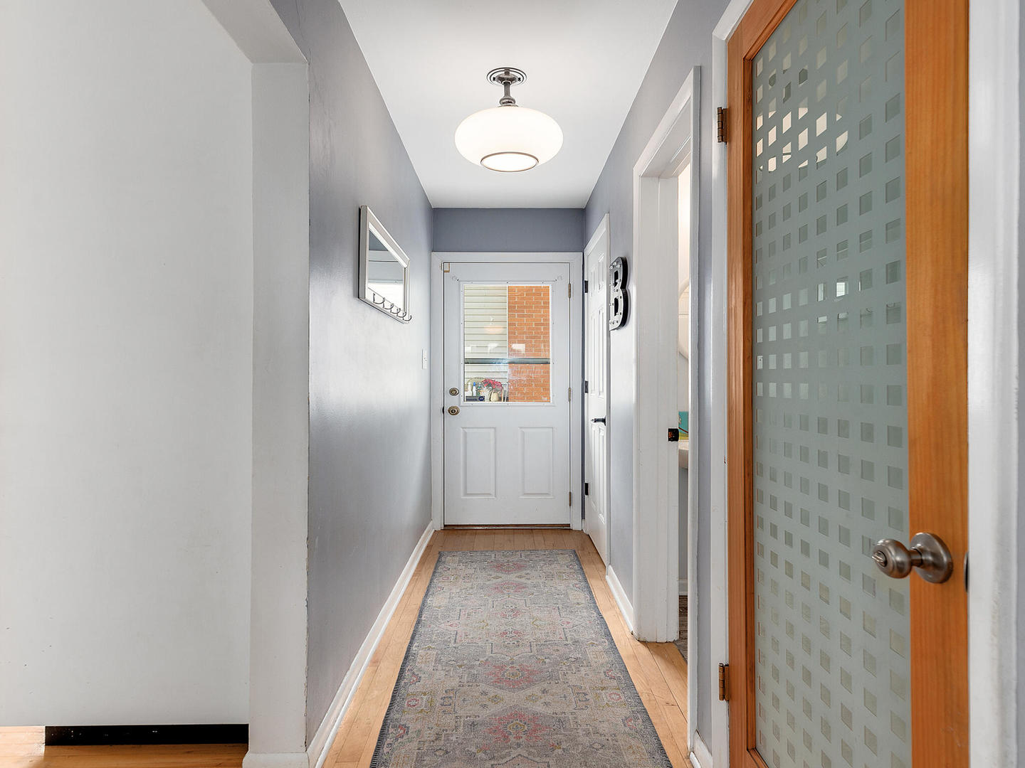 1340 Oak Street Western Springs, IL 60558 - Photo 14 of 25 a view of a hallway with wooden floor and a bathroom