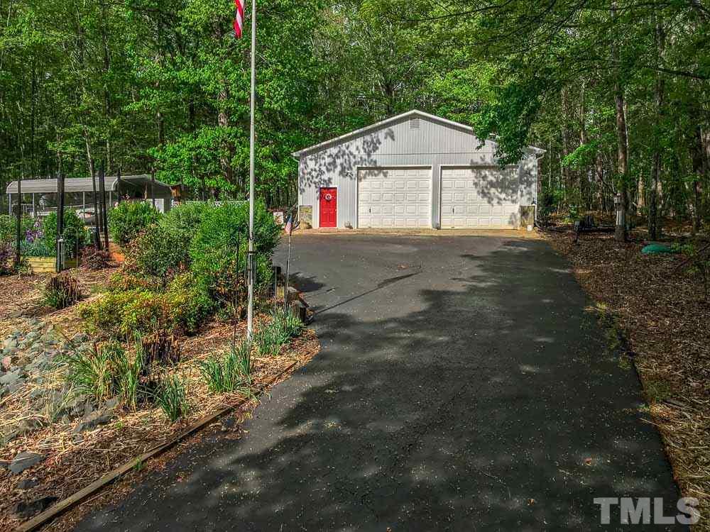 6407 Craig Road Durham, NC 27712 - Photo 22 of 25 Visually pleasing!! Detached Garage / Workshop ~ crafts or home business. 1500 SF of heated space w Gas Wall unit & ceiling fans. Hot/Cold running water, benches, shelves & more! 12 ft ceilings & dual 10ft dble drs allow anything ~ motor home to enter.