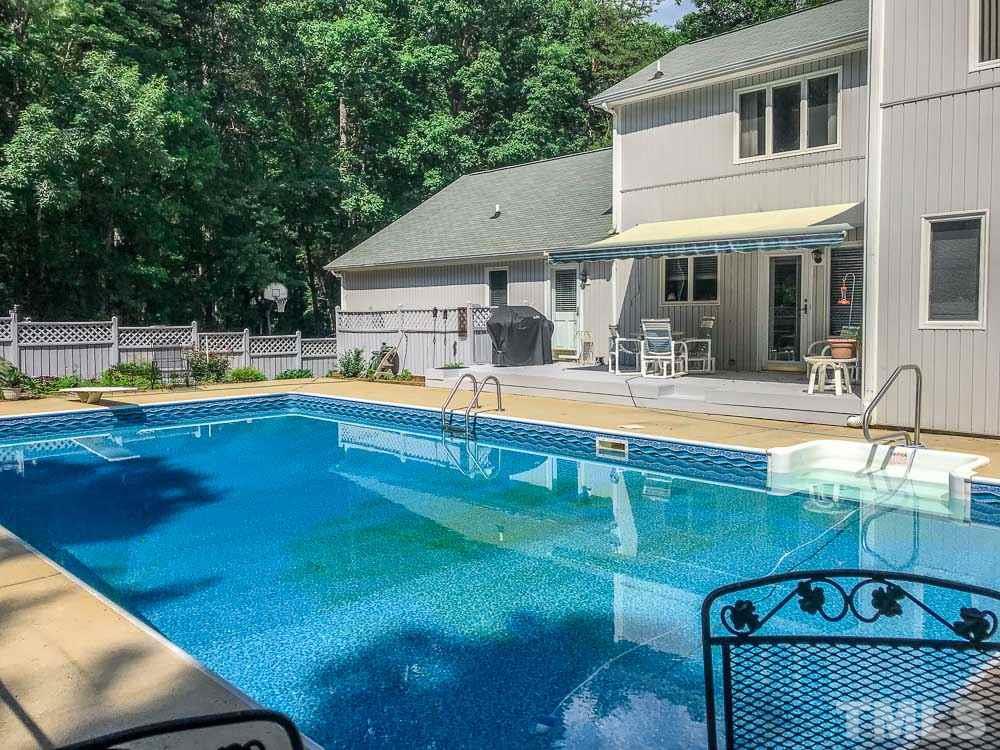 6407 Craig Road Durham, NC 27712 - Photo 5 of 25 57 x 34 Pool Patio surround w 27 x 10 sun shaded raised deck (Sunsetter Electric Awning opens in 60 seconds and even closes automatically if wind moves it too much!!)