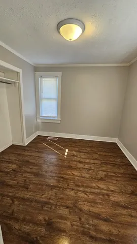 a view of a room with wooden floor and window