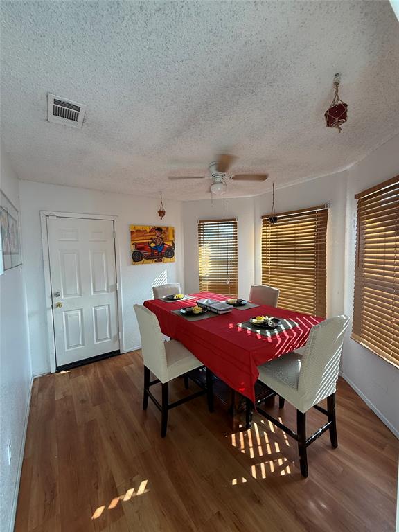 509 Bethlehem Street Terrell, TX 75160 - Photo 7 of 13 Dining area featuring a textured ceiling, wood finished floors, and a ceiling fan