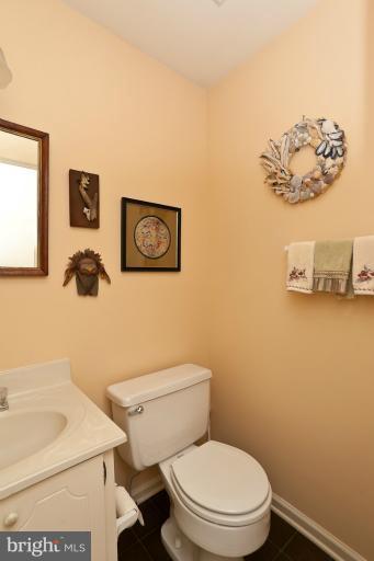6617 Weymouth Road Baltimore, MD 21212 - Photo 14 of 30 a white toilet sitting next to a white sink and vanity