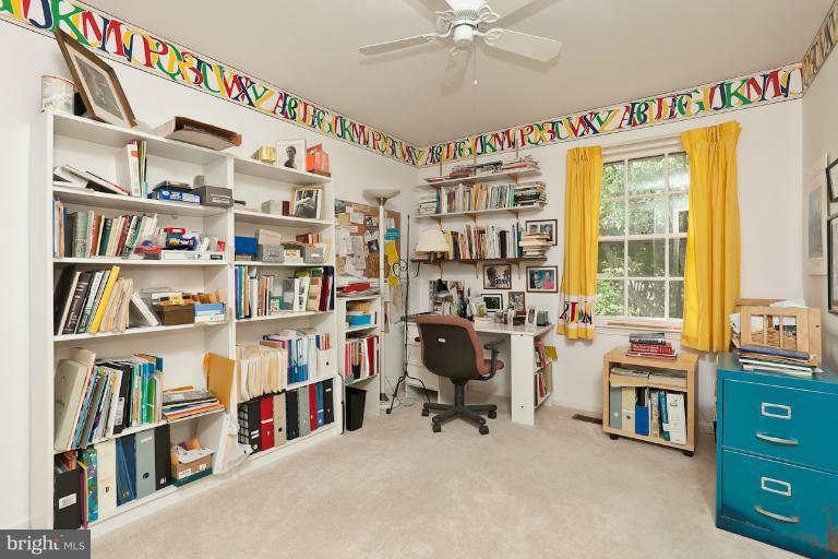 6617 Weymouth Road Baltimore, MD 21212 - Photo 16 of 30 a view of a workspace with furniture and a book shelf