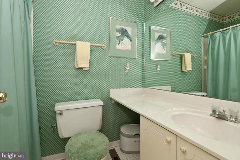 6617 Weymouth Road Baltimore, MD 21212 - Photo 17 of 30 a bathroom with a toilet sink and mirror
