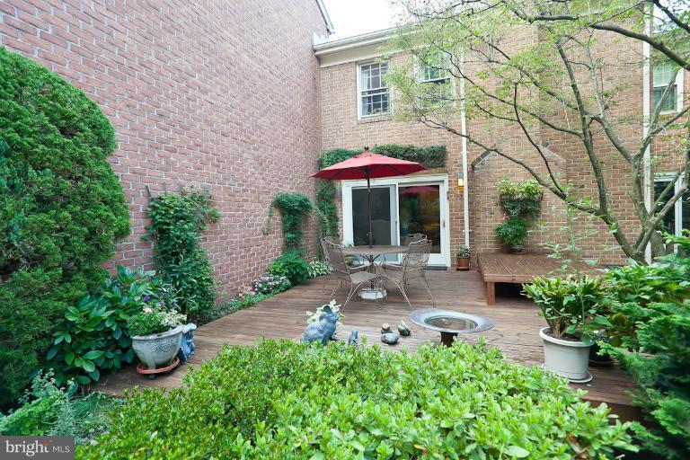 6617 Weymouth Road Baltimore, MD 21212 - Photo 19 of 30 a view of a patio with table and chairs potted plants and large tree