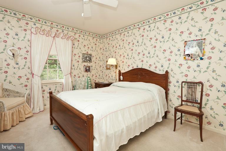 6617 Weymouth Road Baltimore, MD 21212 - Photo 6 of 30 a bedroom with a bed and a chair