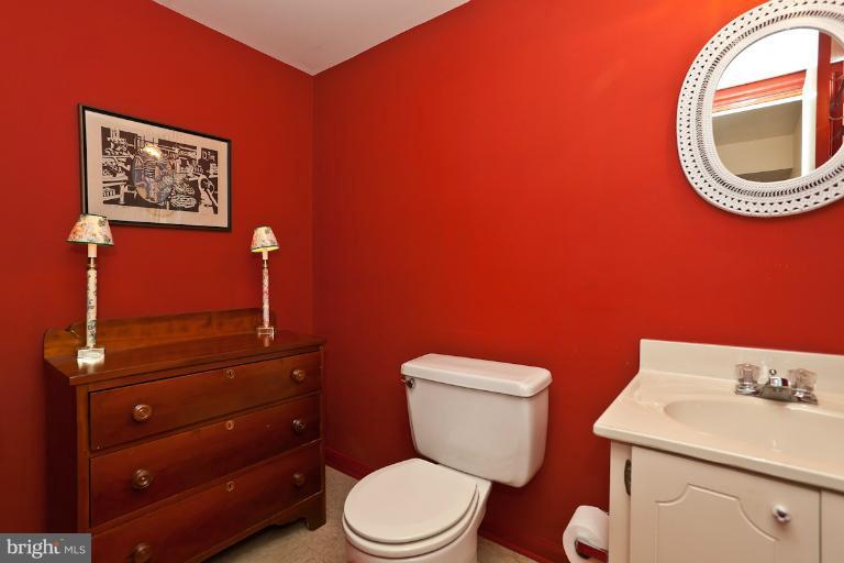 6617 Weymouth Road Baltimore, MD 21212 - Photo 7 of 30 a bathroom with a toilet a sink and mirror